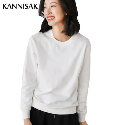 Woman wearing a white sweatshirt with 'KANNISAK' branding on a white background