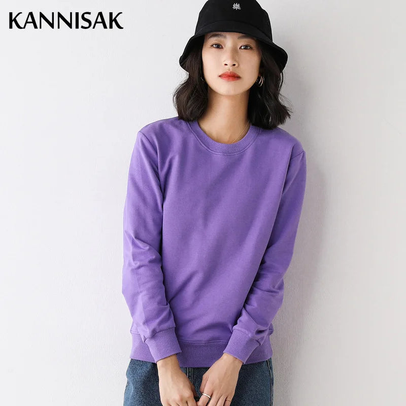Person wearing a purple sweatshirt and black hat against a white background with 'KANNISAK' branding.