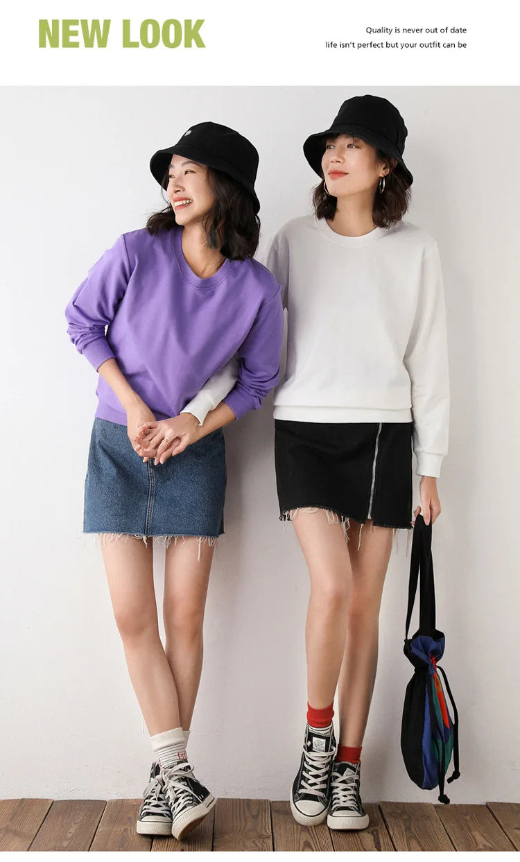 Two women wearing casual outfits with hats and sneakers, standing against a plain background.