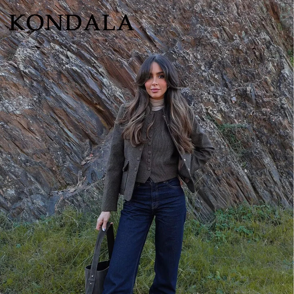 Woman standing in front of a rocky cliff with 'KONDALA' branding.