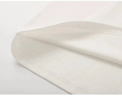 Close-up of a white satin fabric with a plain background