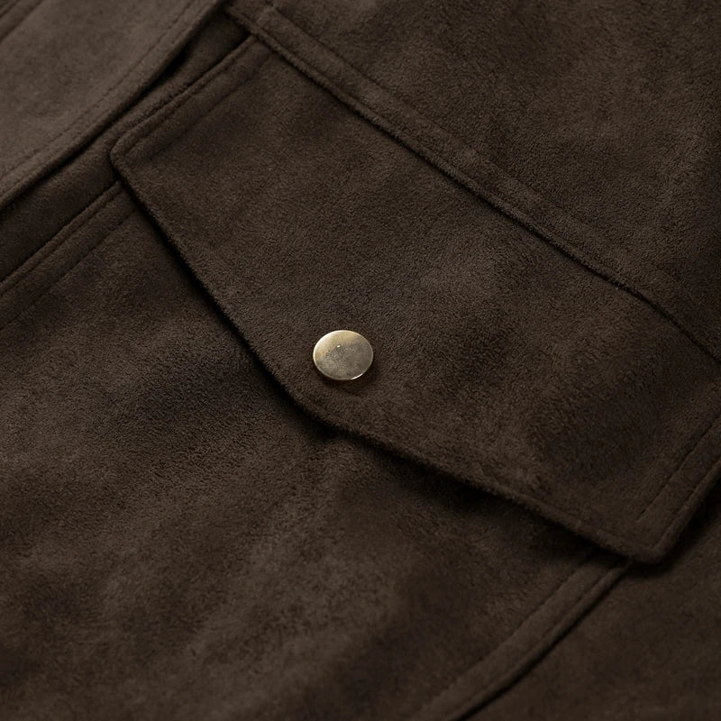 Close-up of a brown suede jacket with a button detail