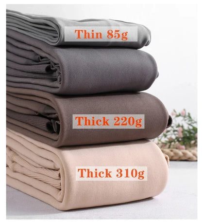 Evlira Thermal Tights folded fabrics display - showing 85g, 220g, 310g weight options with clear labeling