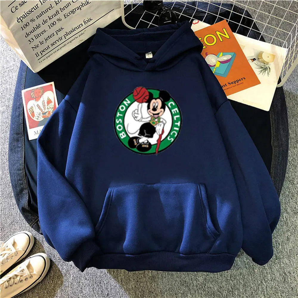 Blue hoodie with a Boston Celtics logo on a gray surface with books and shoes.