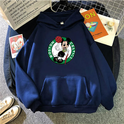 Blue hoodie with a Boston Celtics logo on a gray surface with books and shoes.