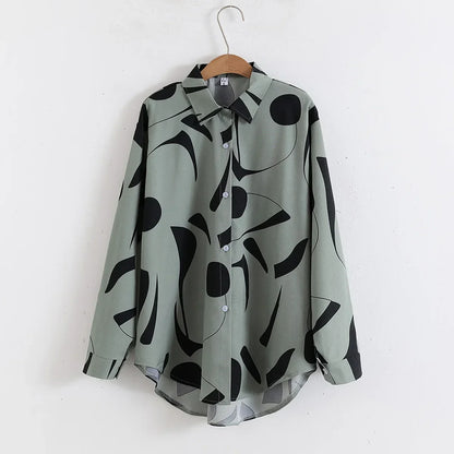 Green shirt with black abstract pattern on a hanger against a white background