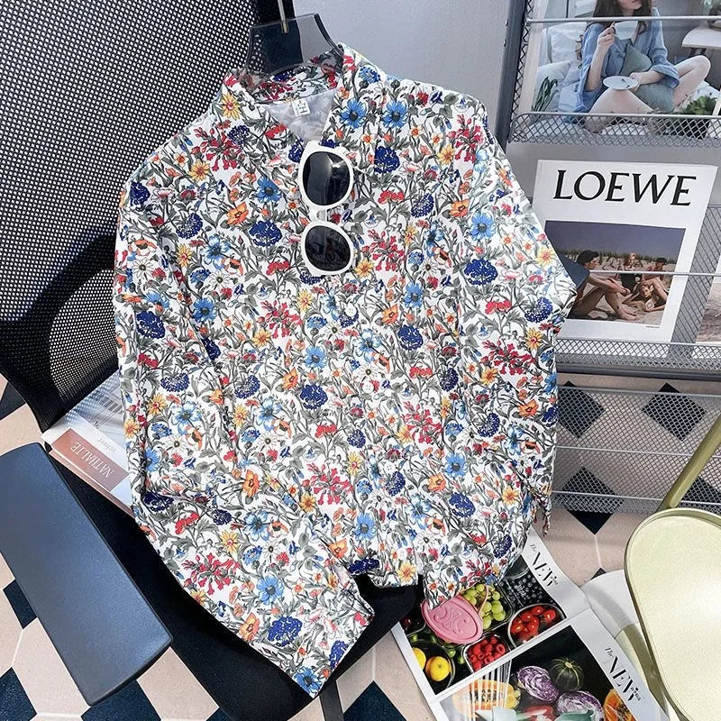 Floral-patterned jacket on a chair with a magazine and sunglasses in the background