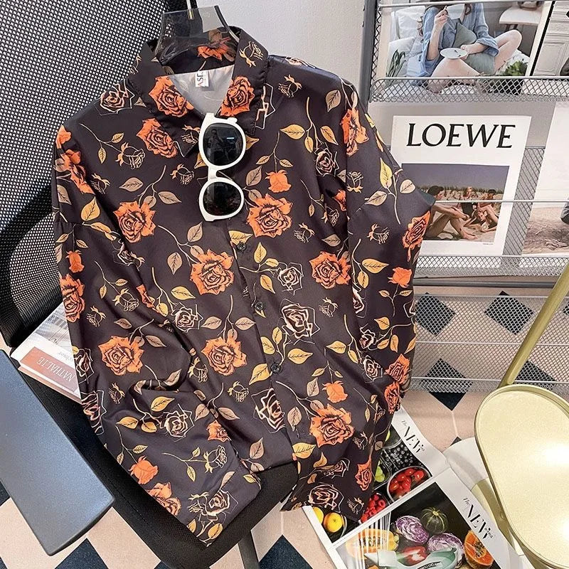 Floral-patterned shirt on a mannequin with sunglasses, placed on a surface with a magazine underneath.