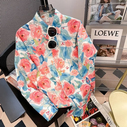 Floral patterned shirt on a mannequin with sunglasses, placed on a magazine, in front of a LOEWE poster.