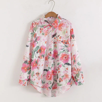 Floral patterned shirt on a hanger against a white background