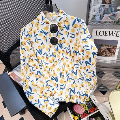 Floral patterned shirt on a chair with a magazine and LOEWE box in the background