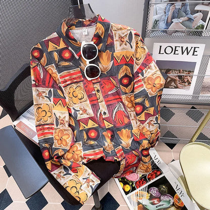 Colorful patterned shirt on a chair with sunglasses, surrounded by magazines including 'LOEWE'.