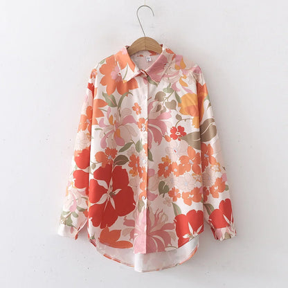 Floral shirt on a hanger against a white background