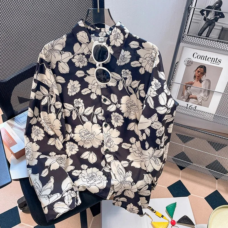 Floral-patterned shirt on a hanger with a magazine in the background