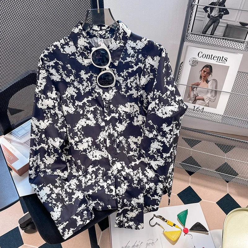 Navy and white floral patterned shirt on a mannequin with sunglasses, placed on a surface.
