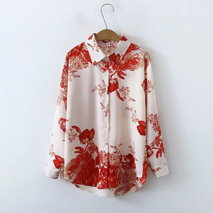 White shirt with red floral pattern on a wooden hanger against a white background