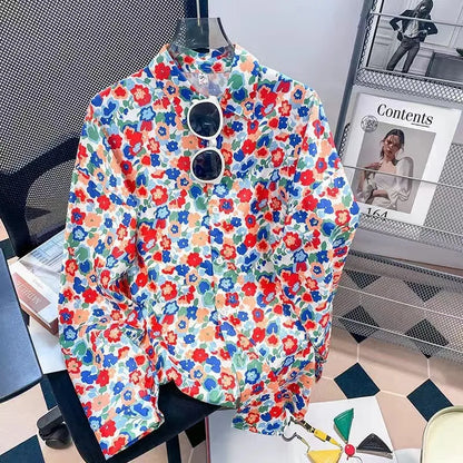 Colorful floral-patterned shirt on a chair with a magazine in the background