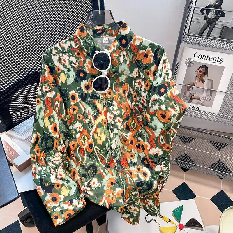 Floral patterned jacket on a chair with sunglasses on top, in an indoor setting.