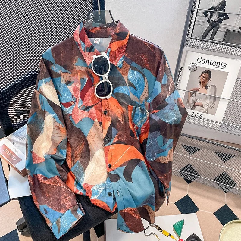 Colorful patterned shirt on a hanger with sunglasses, placed on a chair.