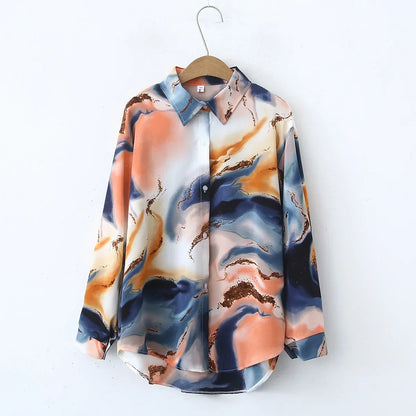 Colorful marble-patterned shirt on a hanger against a white background