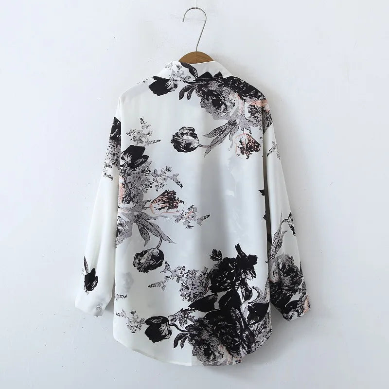 Floral patterned shirt on a hanger against a white background
