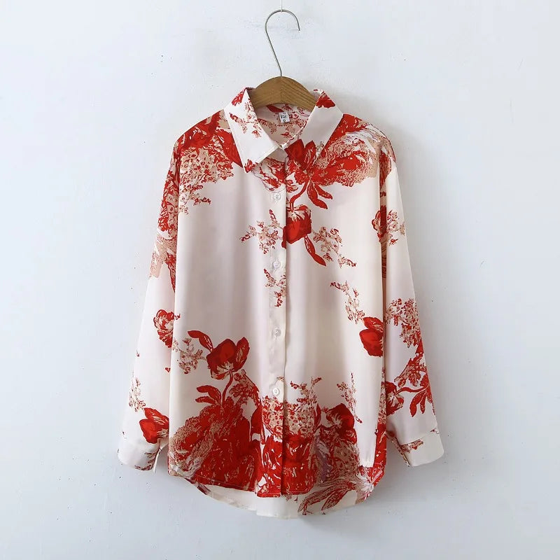 White shirt with red floral pattern on a wooden hanger against a white background