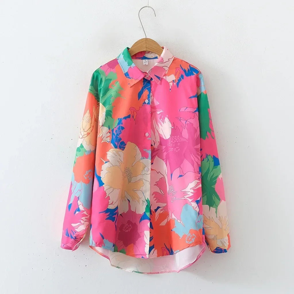 Colorful floral shirt on a hanger against a white background