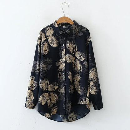 Navy blue shirt with beige leaf pattern on a hanger against a white background