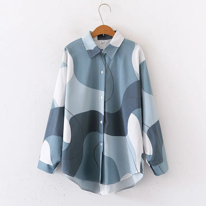 Blue and white patterned shirt on a hanger against a white background