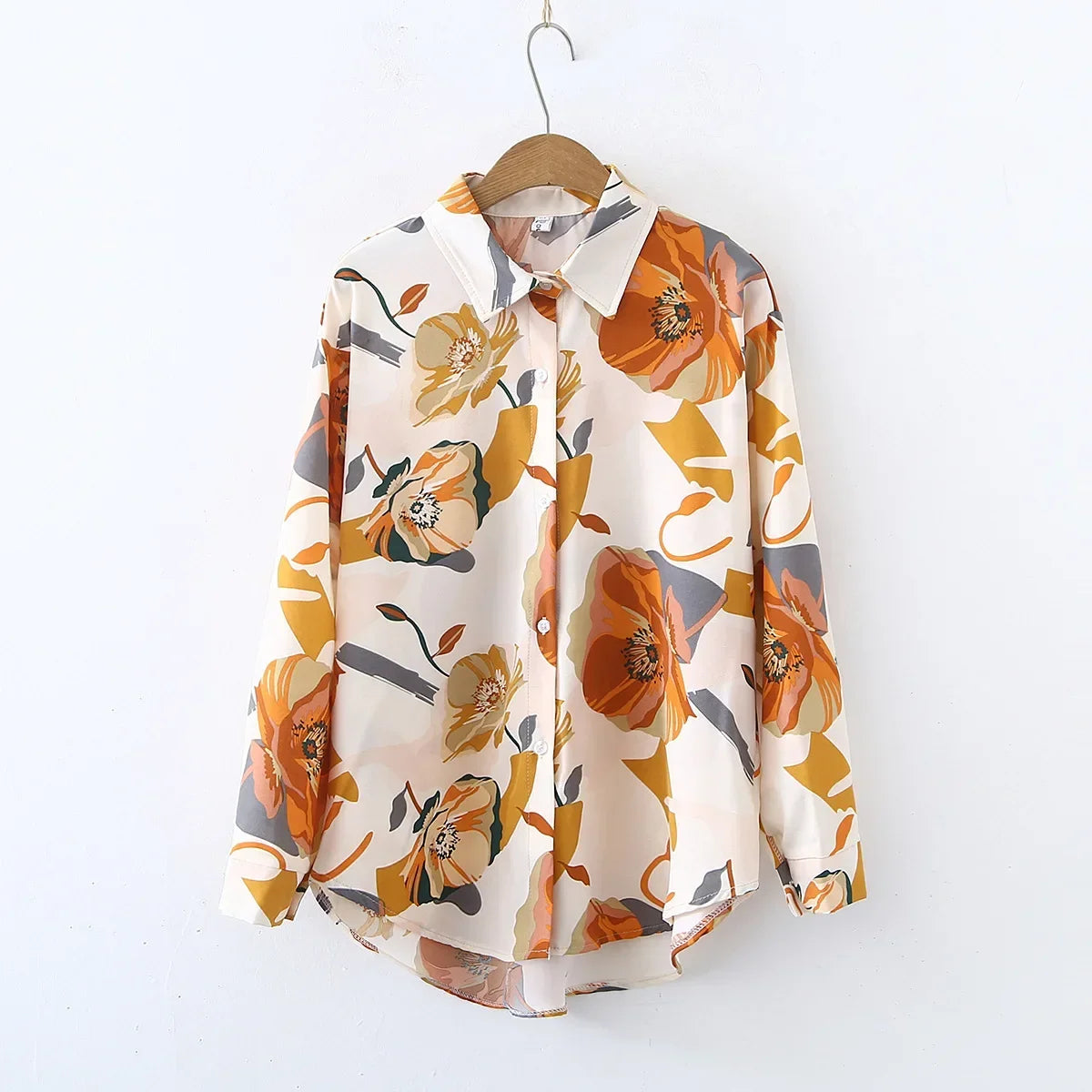 Floral patterned shirt on a hanger against a white background