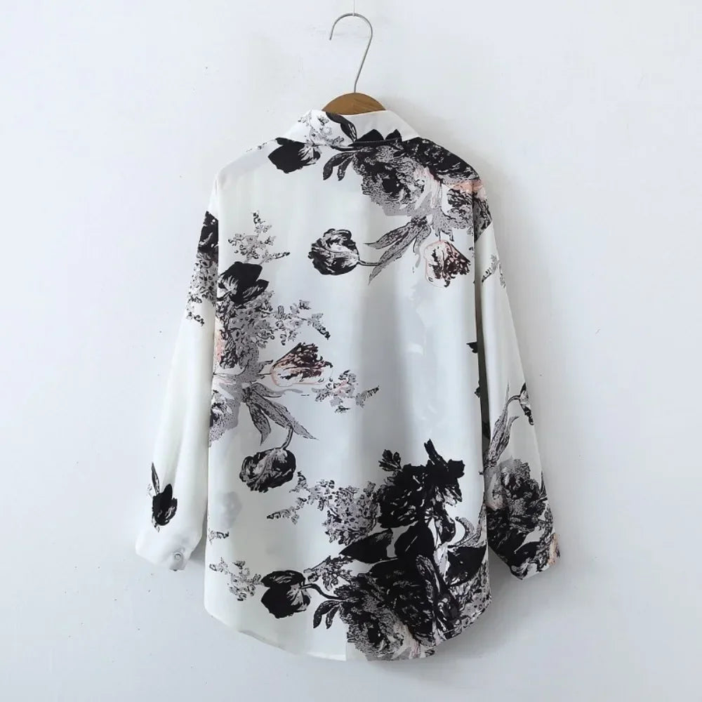Floral patterned shirt on a hanger against a white background
