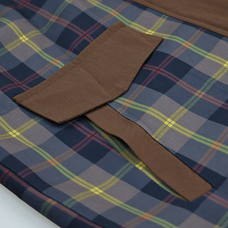 Brown fabric strip on a blue plaid fabric background