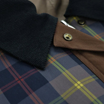 Close-up of a plaid fabric with a button and dark collar