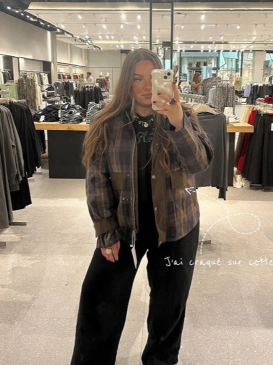 Person wearing a plaid jacket in a clothing store