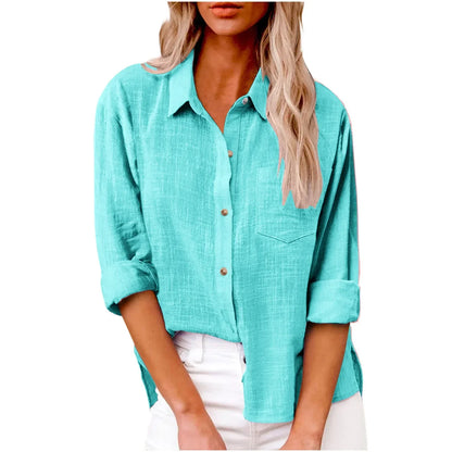 Woman wearing a turquoise button-up shirt with rolled-up sleeves on a white background