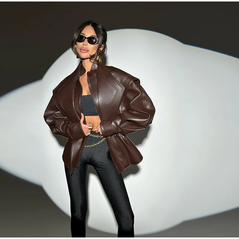 Person wearing a brown leather jacket and sunglasses on a white background