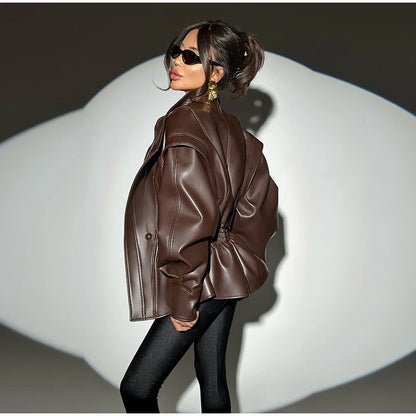 Woman wearing a brown leather jacket on a white background
