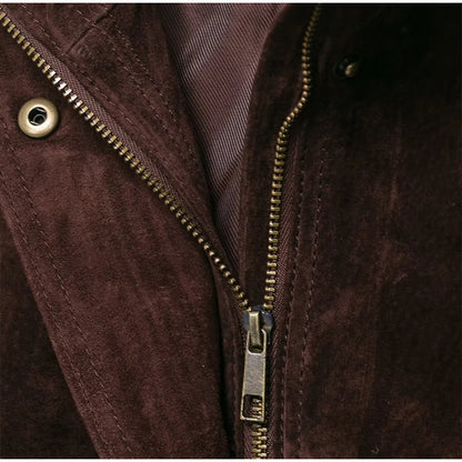 Close-up of a brown jacket with a zipper and button details.