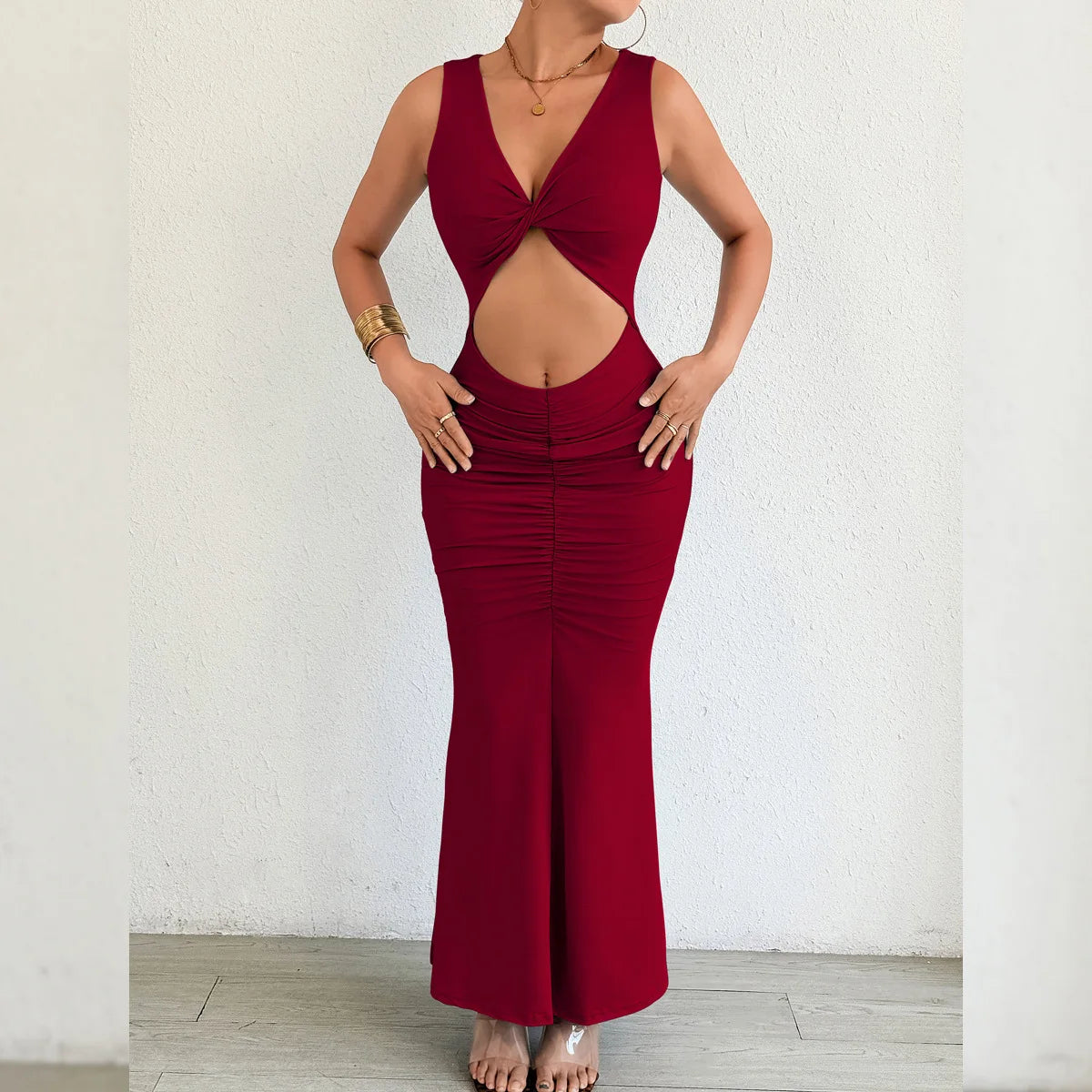 Red jumpsuit with cut-out design worn by a person against a white background