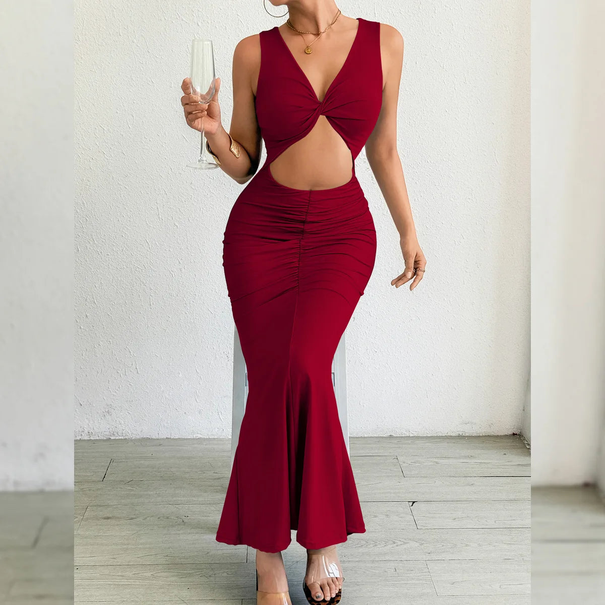 Red evening gown with cut-out design on a white background