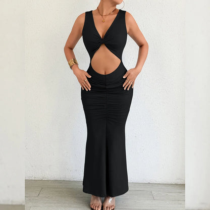 Black dress with cut-out design worn by a person against a white background