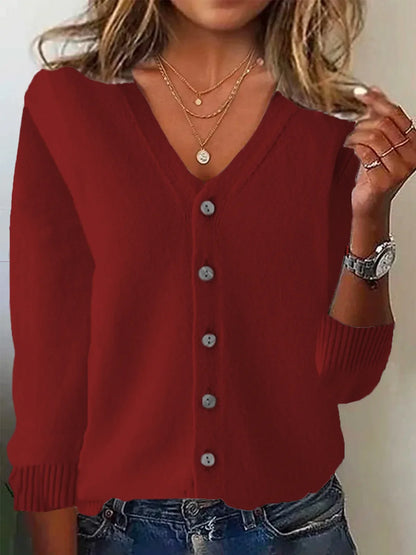 Red cardigan worn by a person with a neutral background