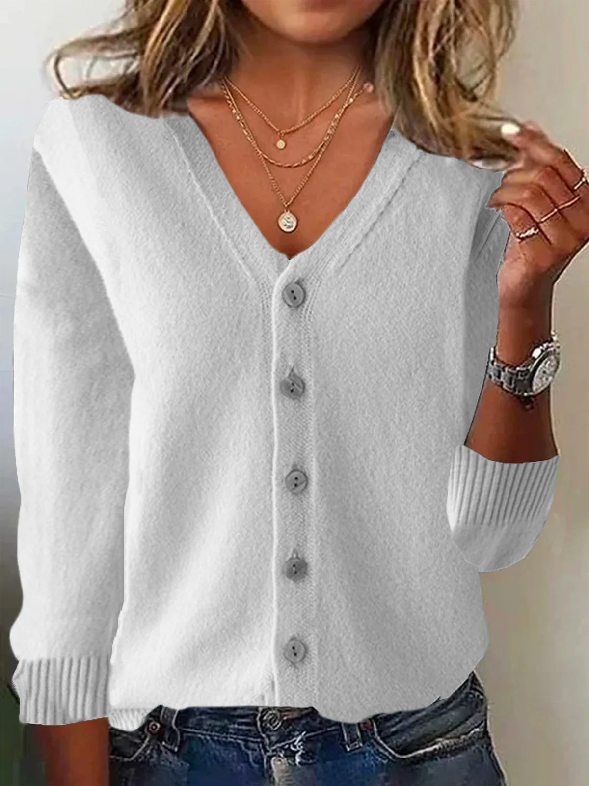 White cardigan worn by a person with a neutral background