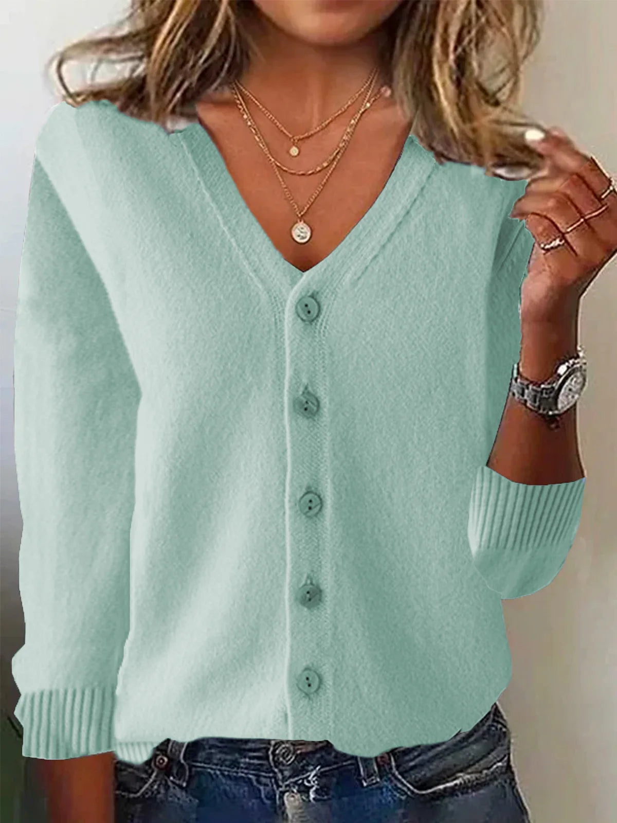 Light blue cardigan worn by a person with a neutral background