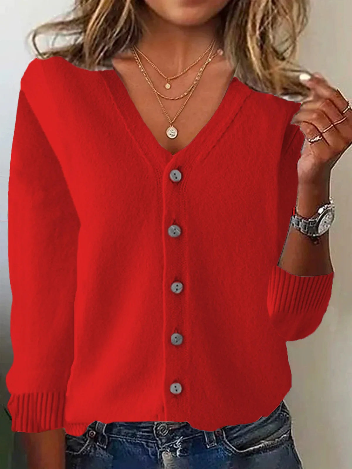 Red cardigan worn by a person with a neutral background