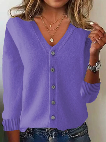 Purple cardigan worn by a person with a neutral background