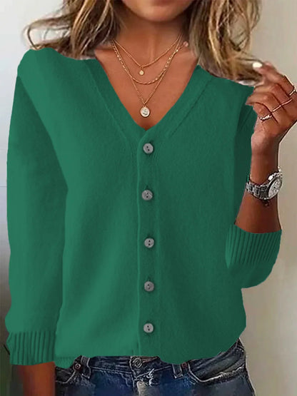 Green cardigan worn by a person with a neutral background