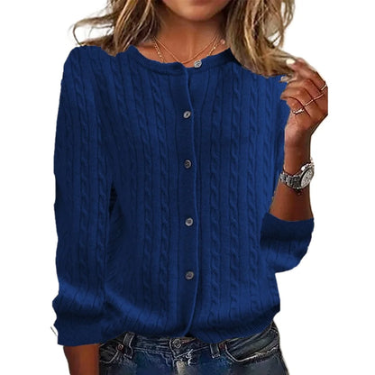 Blue cable knit cardigan worn by a person on a white background