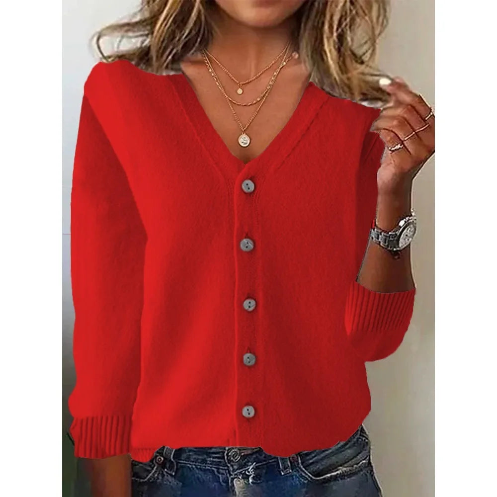 Red cardigan worn by a person with a neutral background