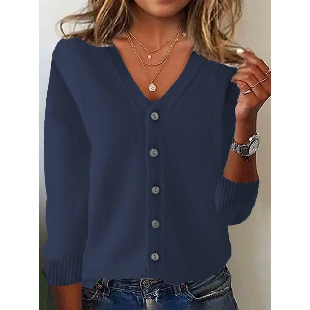 Navy blue cardigan worn by a person with a neutral background